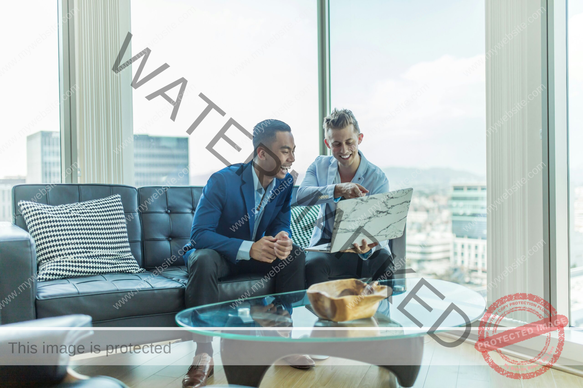 two men in suit sitting on sofa